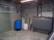 Unfinished basement area with water storage tank and water filtration system at 105 Lake Rd, Henderson, NC 27537