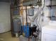 Unfinished basement with water heater and laundry hookups at 105 Lake Rd, Henderson, NC 27537