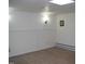 Finished basement with painted white walls and carpeting at 105 Lake Rd, Henderson, NC 27537