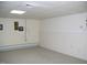 Bright basement area featuring neutral carpeting and a long baseboard heater at 105 Lake Rd, Henderson, NC 27537