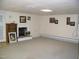 Spacious basement with neutral carpeting, fireplace, and ample wall space for decor at 105 Lake Rd, Henderson, NC 27537