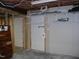 Unfinished basement with storage shelving and access doors at 105 Lake Rd, Henderson, NC 27537