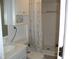 Bathroom with floral shower curtain and white fixtures at 105 Lake Rd, Henderson, NC 27537