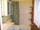 Bathroom with a shower/tub combo, light vanity, and mirrored cabinet at 105 Lake Rd, Henderson, NC 27537