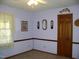 Bedroom featuring chair-rail detail and a window with sheer, lacey curtains at 105 Lake Rd, Henderson, NC 27537