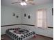 Cozy bedroom featuring a ceiling fan and a comfortable bed with patterned quilt at 105 Lake Rd, Henderson, NC 27537
