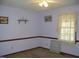 Bedroom with a ceiling fan, a window with lace curtains, and neutral-colored carpet at 105 Lake Rd, Henderson, NC 27537