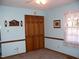 Cozy bedroom featuring light blue walls, plush carpeting, and a window with sheer curtains at 105 Lake Rd, Henderson, NC 27537