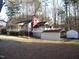 Charming single-Gathering home features an inviting covered porch and a spacious backyard with mature trees at 105 Lake Rd, Henderson, NC 27537
