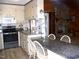 Well-equipped kitchen with modern appliances and a breakfast bar at 105 Lake Rd, Henderson, NC 27537