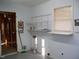 Functional laundry room with utility sink, shelving, and good natural light at 105 Lake Rd, Henderson, NC 27537