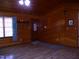 Inviting living room featuring wood-paneled walls and ample natural light at 105 Lake Rd, Henderson, NC 27537