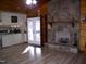 Open-concept living room with a stone fireplace and access to the kitchen at 105 Lake Rd, Henderson, NC 27537