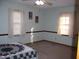 Serene main bedroom featuring plush carpeting and ample natural light at 105 Lake Rd, Henderson, NC 27537