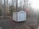 Exterior view of an outbuilding with white walls and a brown roof at 105 Lake Rd, Henderson, NC 27537