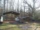 Exterior view of multiple outbuildings and carports at 105 Lake Rd, Henderson, NC 27537