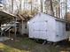 Exterior view of multiple outbuildings, including a covered carport at 105 Lake Rd, Henderson, NC 27537