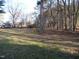 View of a large, grassy yard with mature trees at 105 Lake Rd, Henderson, NC 27537