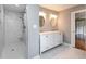 Bathroom featuring a tiled walk-in shower and double vanity with marble countertops at 1305 Glen Eden Dr, Raleigh, NC 27612