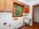 Functional laundry room with a utility sink and a window providing natural light at 1305 Glen Eden Dr, Raleigh, NC 27612