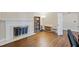 Inviting living room with a fireplace, hardwood floors, and ample natural light at 1401 Granada Dr, Raleigh, NC 27612