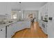 Bright kitchen features stainless steel appliances and a view into the breakfast nook at 1607 Royal Red Trl, Apex, NC 27502