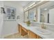 Bathroom featuring double sinks, large mirror, window, and tile flooring at 1753 Kingston Heath Way, Raleigh, NC 27604