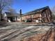 Image showcasing brick exterior, paved parking pad, covered carport and landscaping at 1926 W Front St, Burlington, NC 27215