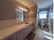 Bathroom featuring purple walls, tile and a large mirror at 1926 W Front St, Burlington, NC 27215
