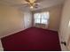 Bedroom with neutral walls, red carpet, and double door closet at 1926 W Front St, Burlington, NC 27215