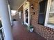 Close-up featuring an inviting porch with decorative plants, brick flooring, and a welcome sign at 1926 W Front St, Burlington, NC 27215