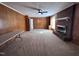 Living room featuring a brick fireplace, neutral carpet and wood paneled walls at 1926 W Front St, Burlington, NC 27215