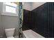 Stylish bathroom showcases a black herringbone-patterned tiled wall and a white tub at 1964 Old Byre Way, Apex, NC 27502