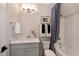 Bright bathroom boasts a tub with white tile surround and a vanity with classic fixtures at 1964 Old Byre Way, Apex, NC 27502