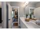 Bathroom with double sink vanity; doorway view of the office with built-in bookcase at 1964 Old Byre Way, Apex, NC 27502