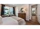 Bedroom boasts a neutral palette, a queen-size bed, two chairs, a bright window for ample natural light at 1964 Old Byre Way, Apex, NC 27502
