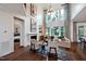 Bright and airy living room with high ceilings, fireplace, large windows, and hardwood floors at 1964 Old Byre Way, Apex, NC 27502