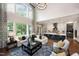 Open concept living room and kitchen featuring high ceilings, hardwood floors, and natural light at 1964 Old Byre Way, Apex, NC 27502