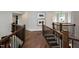 Elegant foyer features hardwood floors, staircase with black iron railing and traditional details at 1964 Old Byre Way, Apex, NC 27502