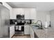 Bright and airy kitchen featuring stainless steel appliances and granite countertops at 202 Austin St # A, Four Oaks, NC 27524