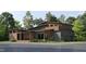 Stunning modern home with a unique roofline, brick accents, and sleek wood and gray siding at 209 Urban Dr, Cary, NC 27511