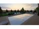 A pristine pool is surrounded by a wooden deck with lounge furniture, and lush landscaping at 214 Reynolds Rd, Raleigh, NC 27609