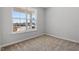 Bright bedroom featuring neutral carpet, light gray walls, and a large window offering pleasant outdoor views at 272 White Oak Garden Way # 209, Garner, NC 27529