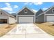 New construction home showcasing an attached garage and concrete driveway at 272 White Oak Garden Way # 209, Garner, NC 27529