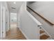 Clean and inviting hallway with hardwood floors and a staircase, creating a welcoming transition between spaces at 272 White Oak Garden Way # 209, Garner, NC 27529