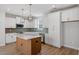 Well-appointed kitchen featuring stainless appliances, a stylish backsplash, a large island and ample cabinet space at 272 White Oak Garden Way # 209, Garner, NC 27529