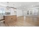 Modern kitchen featuring stainless appliances, stylish lighting, and a large island, seamlessly flowing into the living area at 272 White Oak Garden Way # 209, Garner, NC 27529