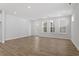 Open-concept living area featuring light hardwood floors and natural light, complemented by white walls at 272 White Oak Garden Way # 209, Garner, NC 27529