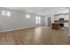 Bright open-concept living space featuring light-colored walls and light-colored hardwood floors, complemented by natural light at 272 White Oak Garden Way # 209, Garner, NC 27529