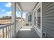 Covered porch with white railing and pillars offers pleasant neighborhood views and exterior house details at 272 White Oak Garden Way # 209, Garner, NC 27529